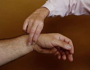 Redlands Chiropractic Doctor Checking for Pulse 